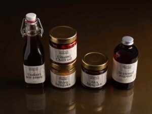 DiningsSW3-Chelsea-Japanesecuisine-FavouritesBoxwithchillioil,soysauce,twomisojars,andabottledNegroni"
